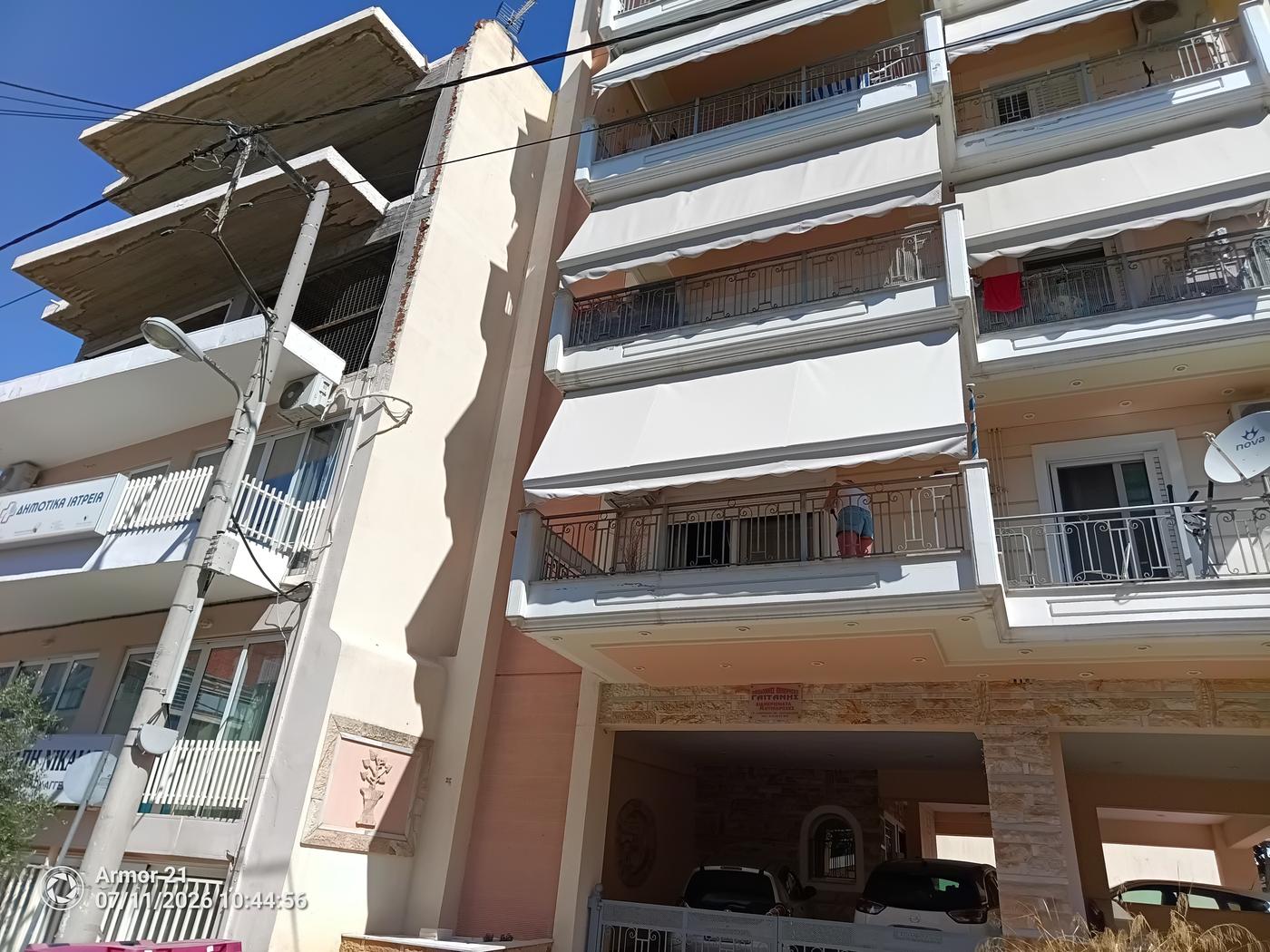 Λευκές κάθετες τέντες σε όροφους πολυκατοικίας